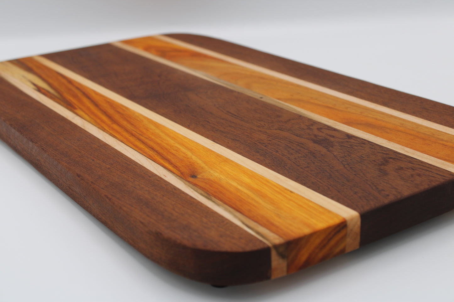 Wooden cutting board with striped pattern on a white background