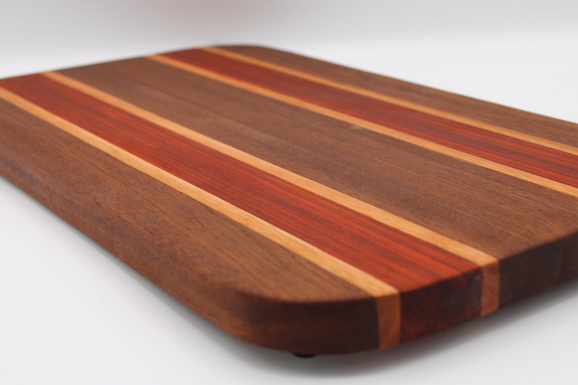 Wooden cutting board with striped pattern on a white background