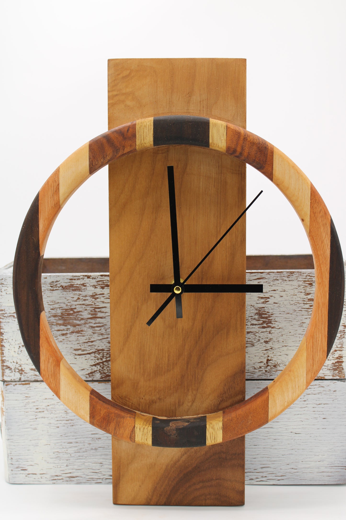 Wooden wall clock with a circular design on a wooden background