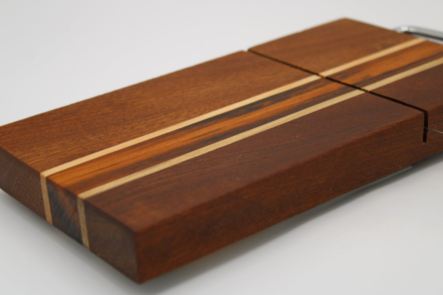 Wooden cheese board with slicer on a white background