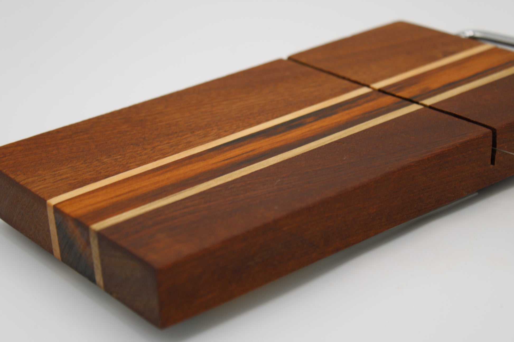 Wooden cheese board with slicer on a white background