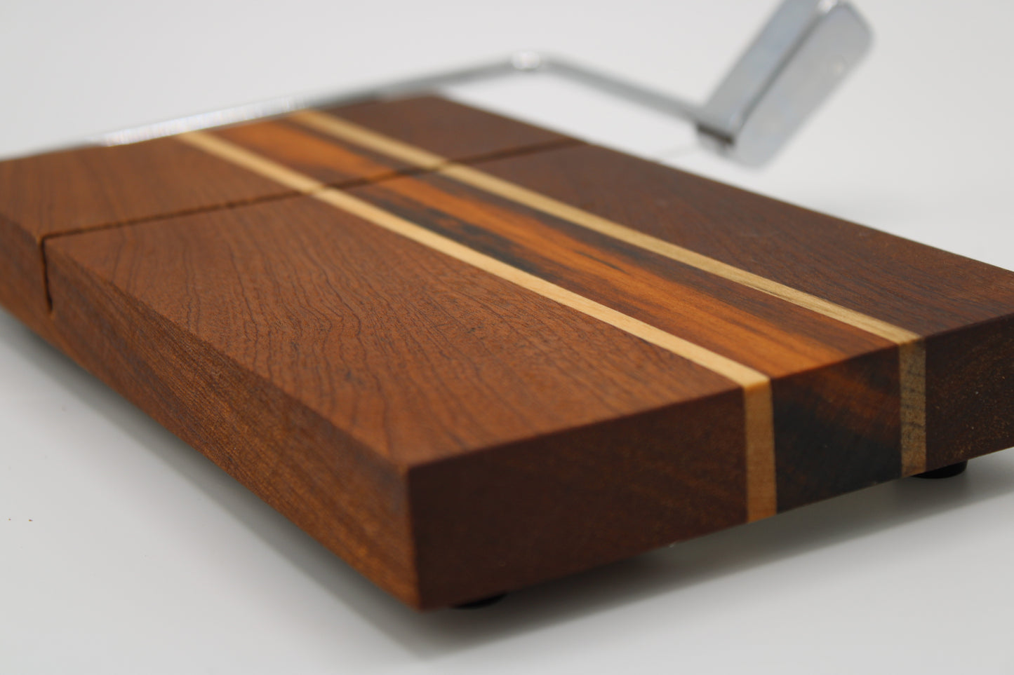 Wooden cheese board with slicer on a white background