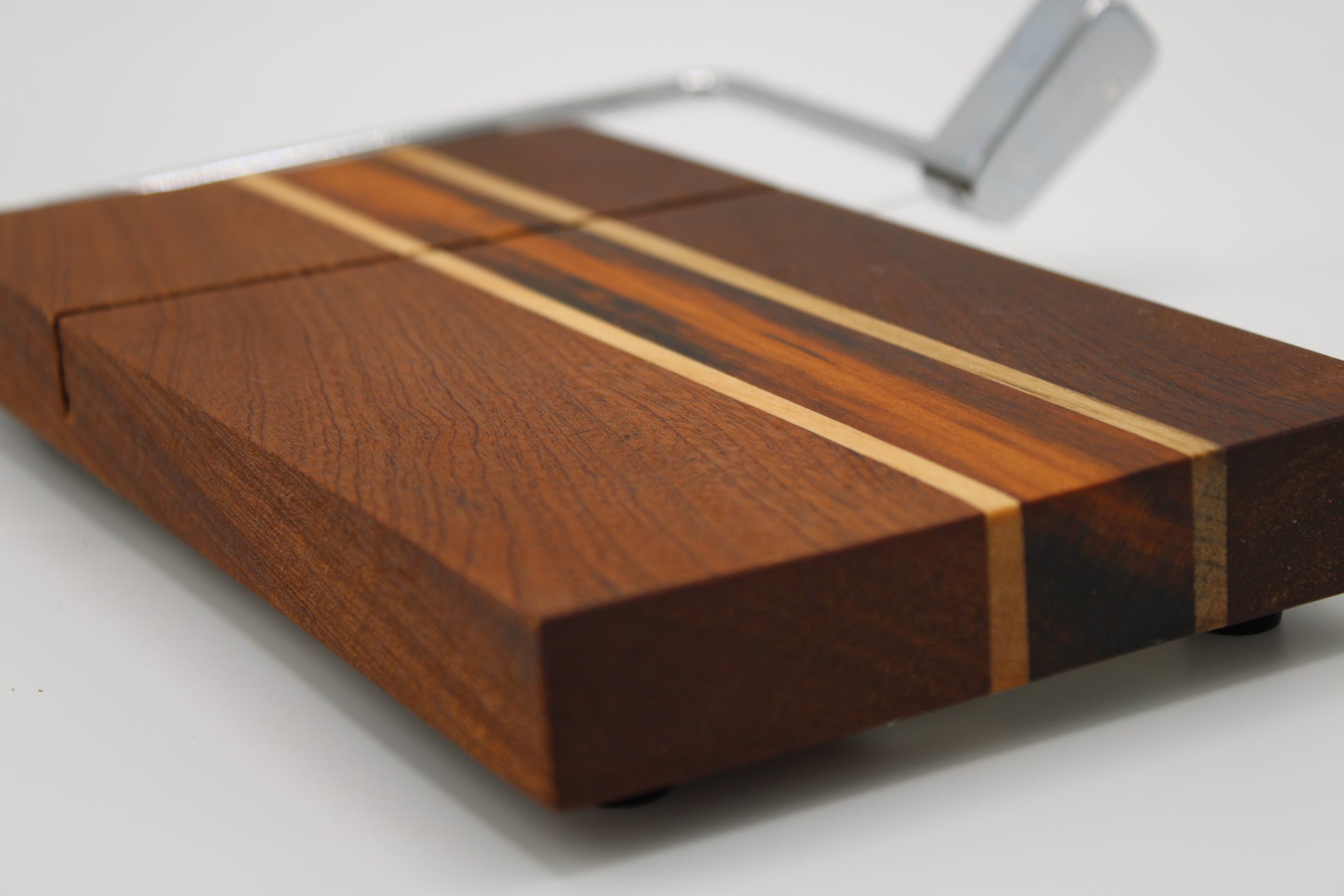 Wooden cheese board with slicer on a white background