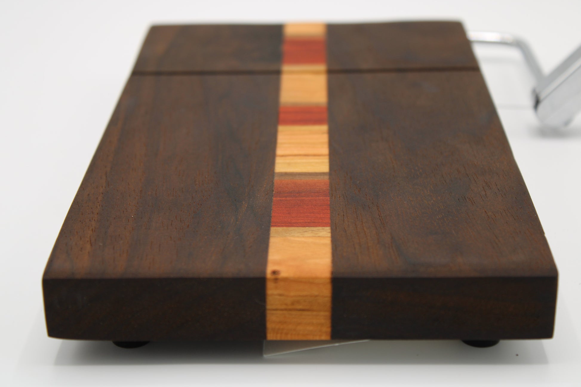 Wooden cutting board with a multicolored stripe on a white background