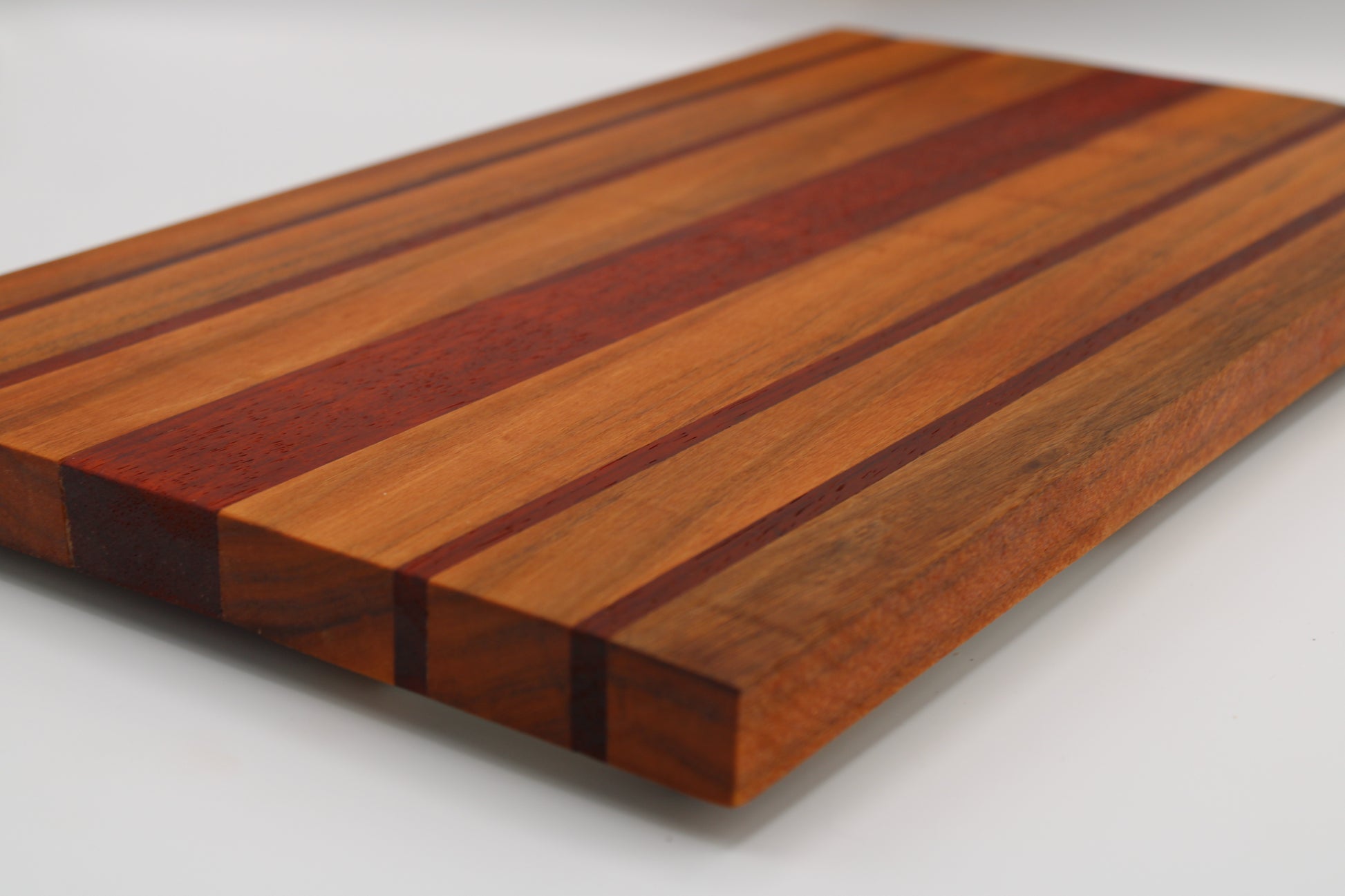 Wooden cutting board with a striped pattern on a white background