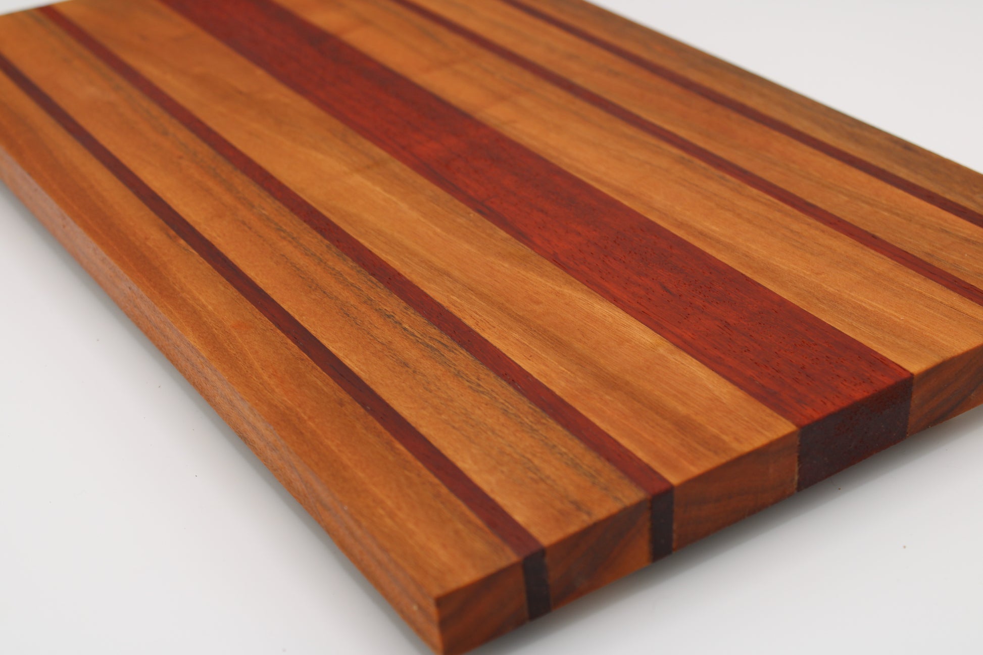 Wooden cutting board with a striped pattern on a white background