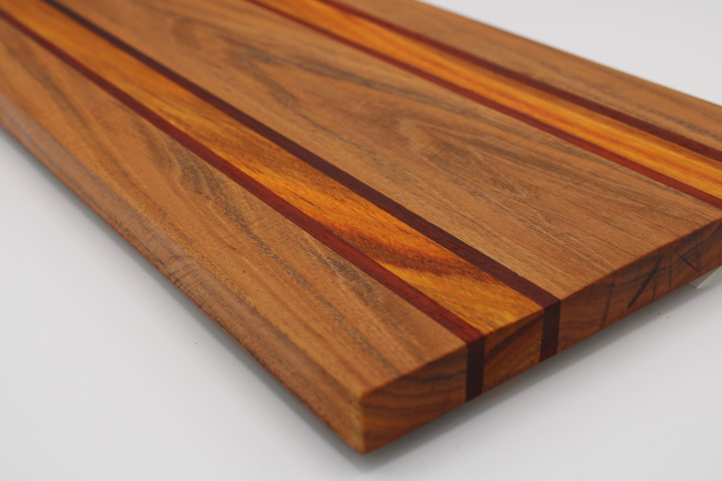 Wooden cutting board with a striped pattern on a white background