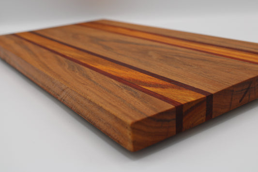 Wooden cutting board with a striped pattern on a white background