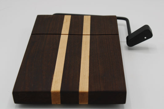 Wooden cheese board with a black slicer on a white background