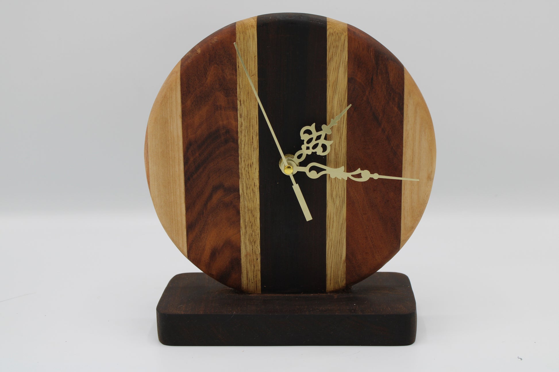 Wooden clock with a unique design on a white background