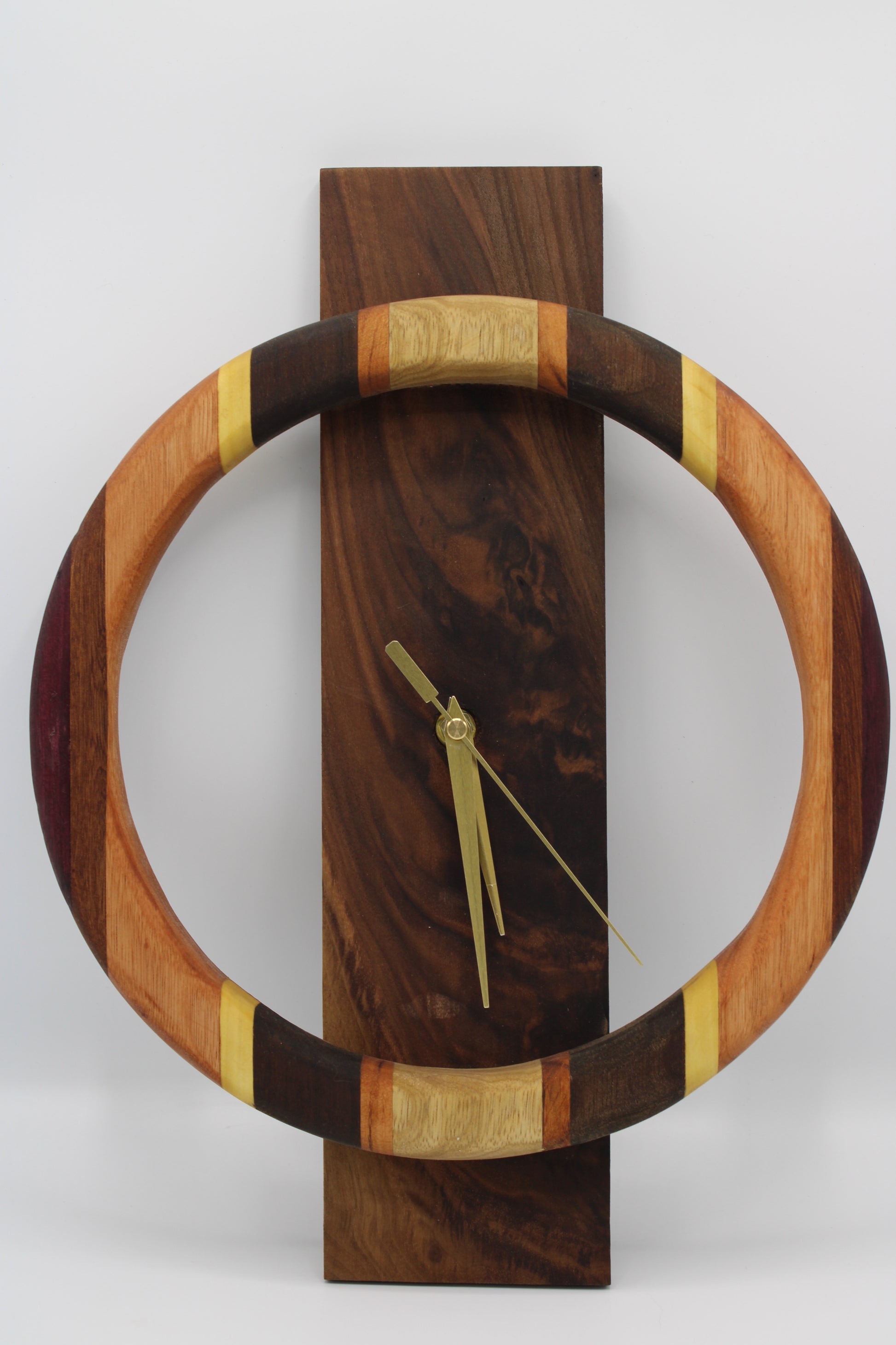 Wooden wall clock with a circular design on a white background