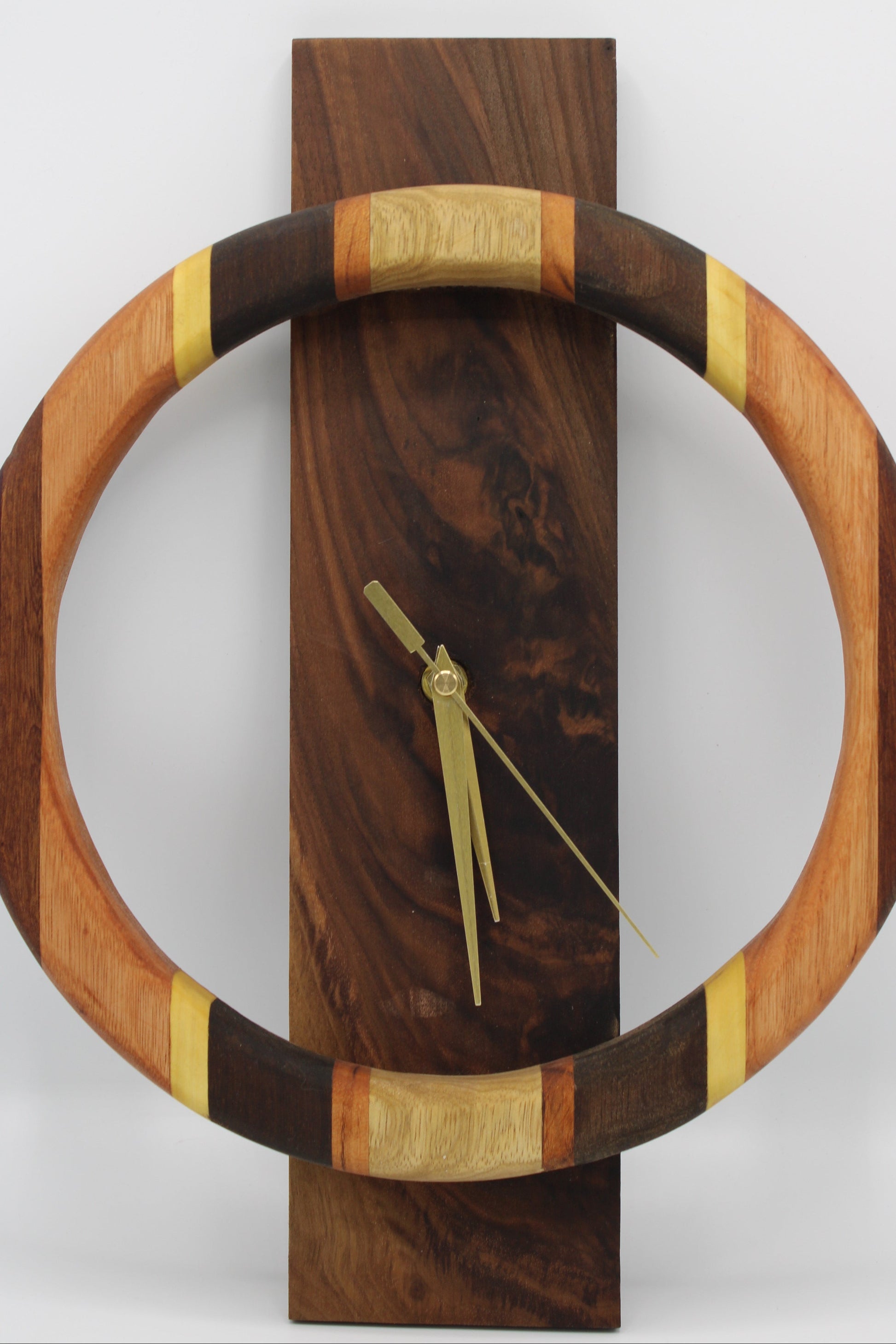 Wooden wall clock with a circular design on a white background