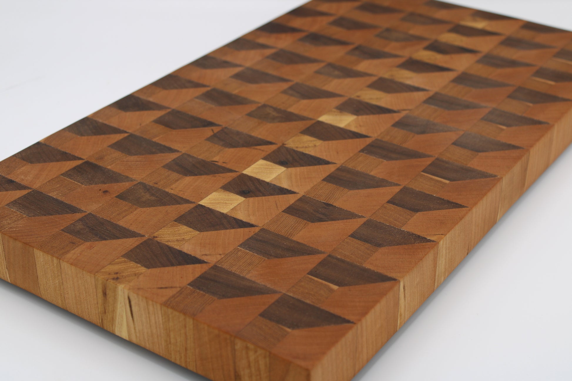 Wooden cutting board with a checkered pattern on a white background