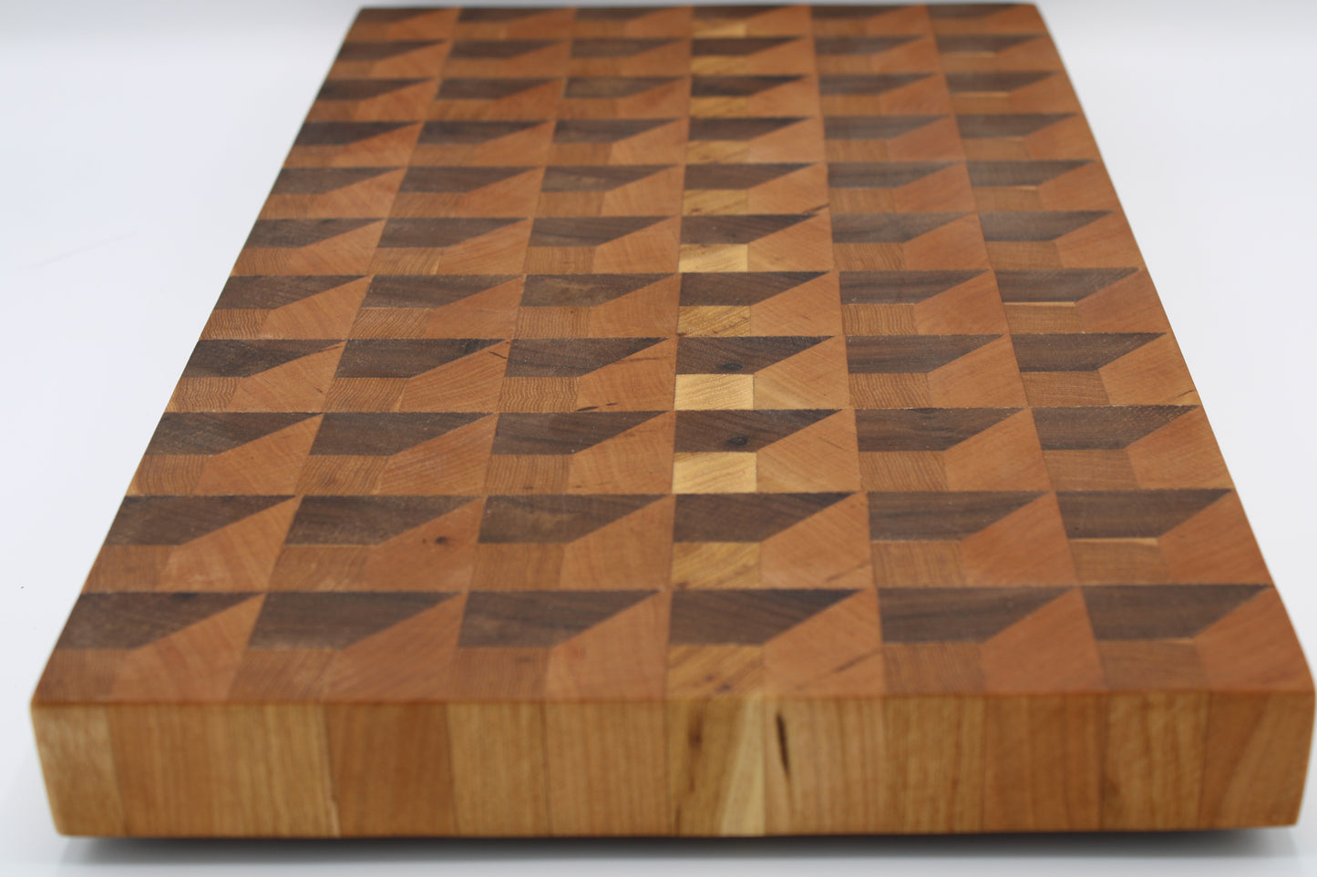 Wooden cutting board with geometric pattern on a white background