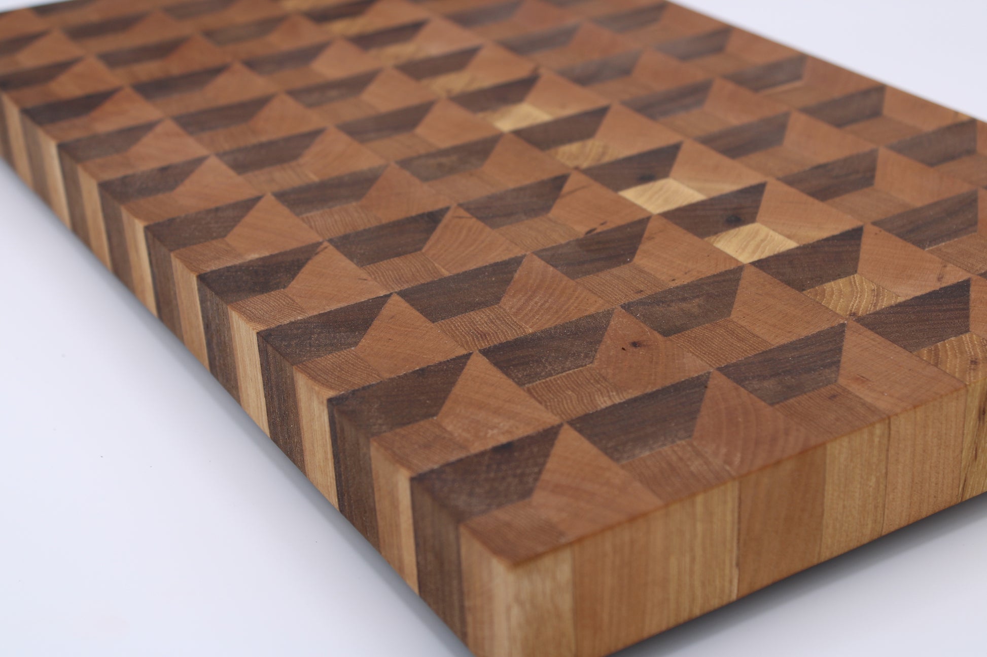 Wooden cutting board with geometric pattern on a white background