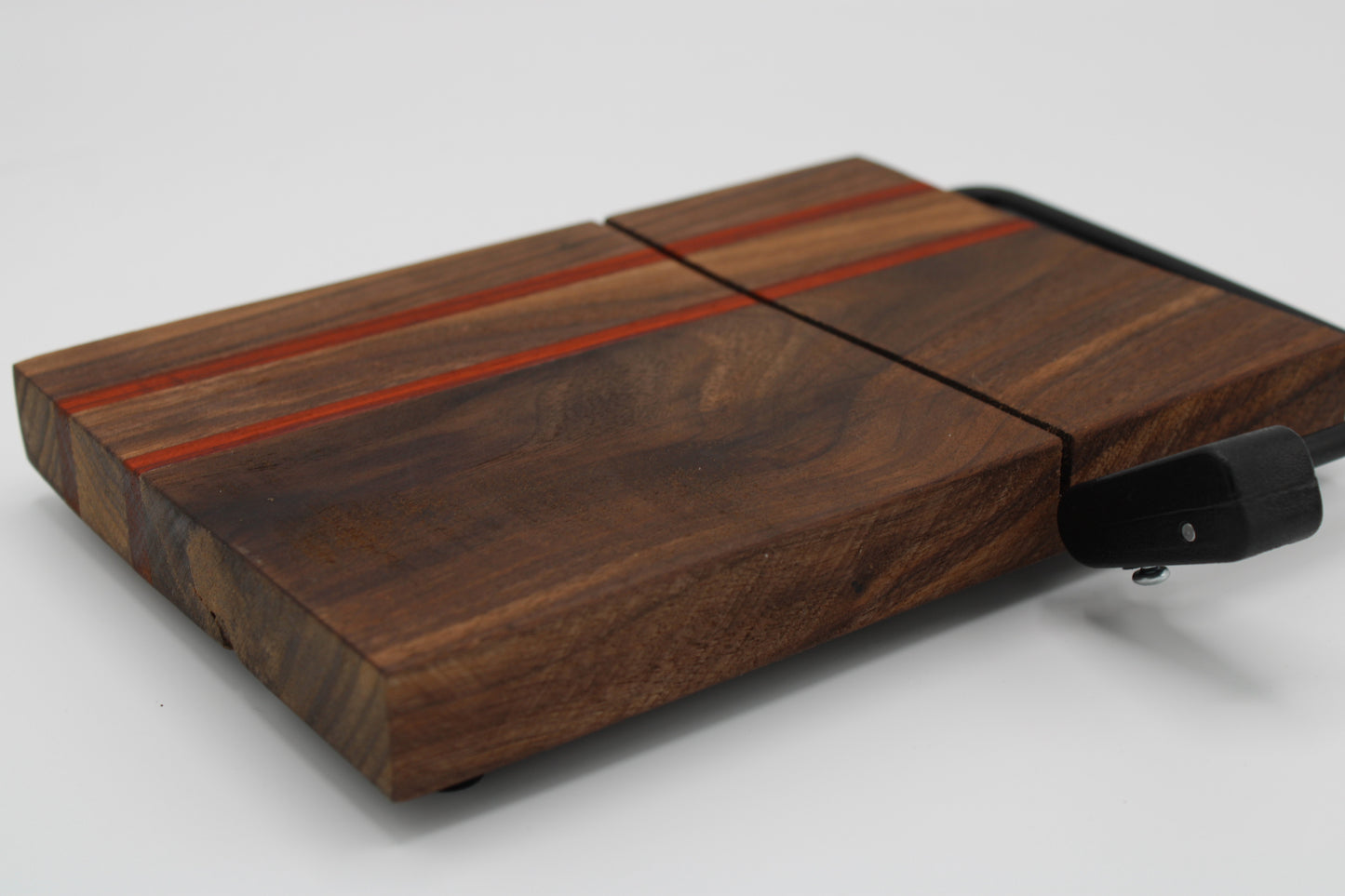 Wooden cheese board with slicer on a white background