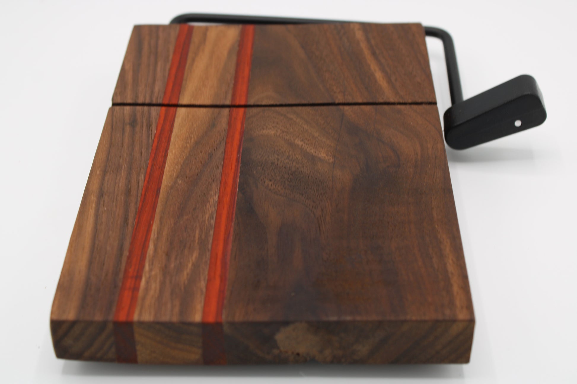 Wooden cheese board with slicer on a white background