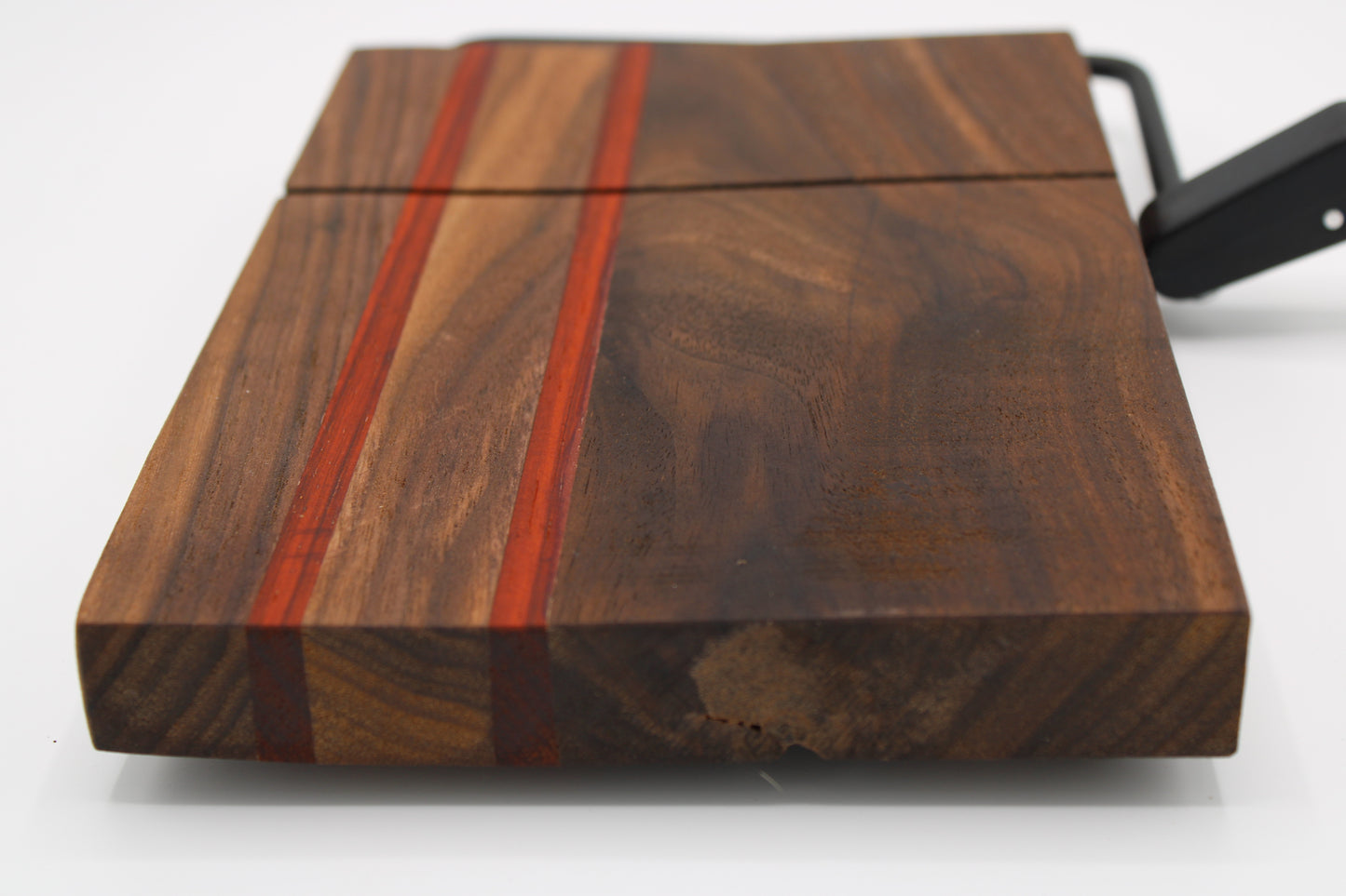 Wooden cheese board with slicer on a white background