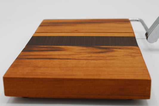 Wooden cheese board with slicer on a white background