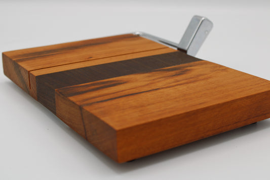Wooden cheese board with slicer on a white background