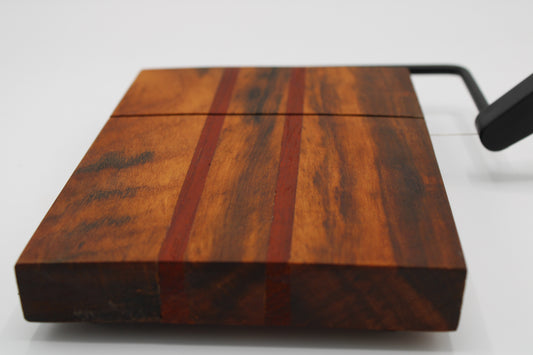 Wooden with cheese board with two red stripes on a white background