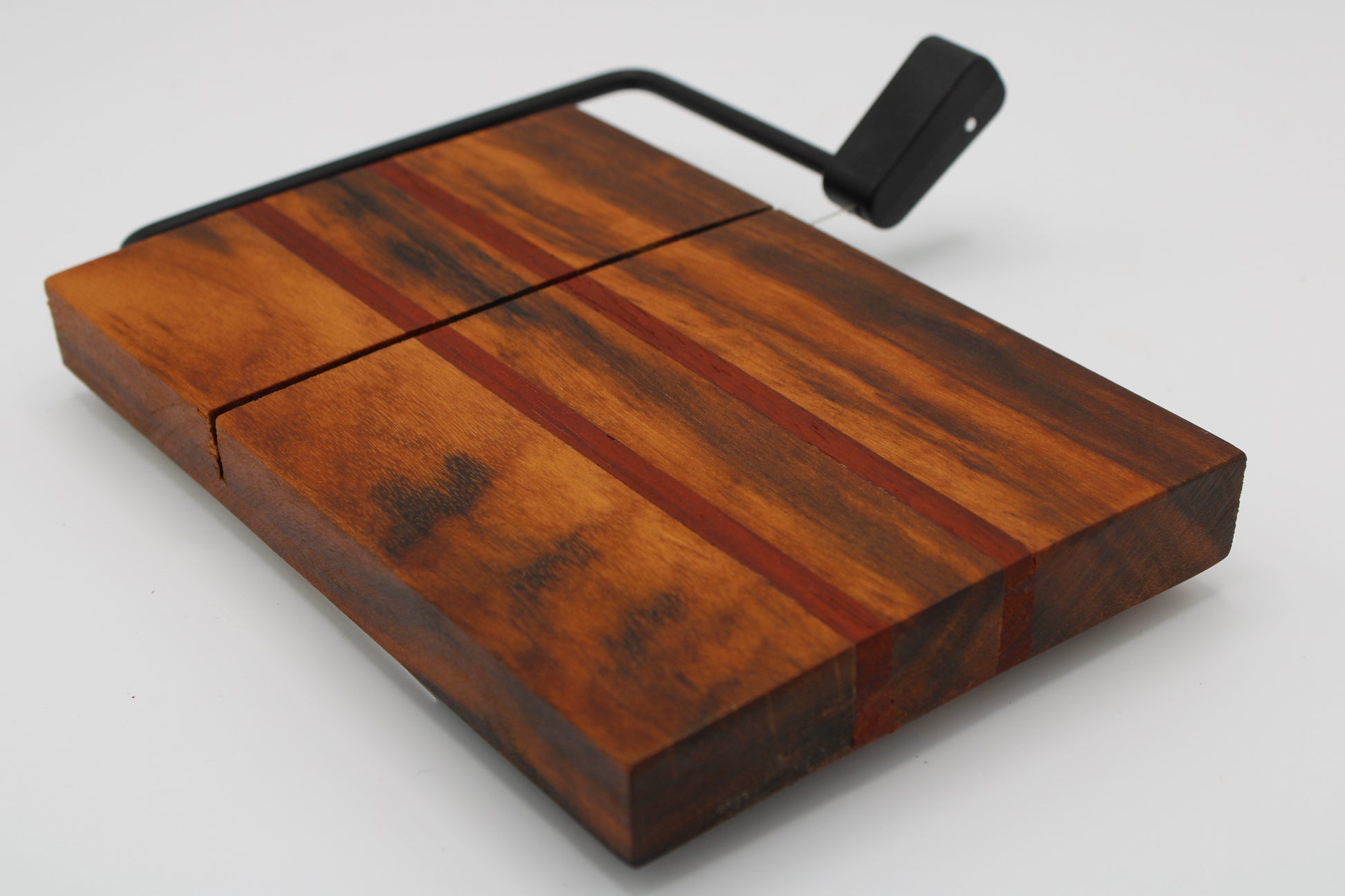 Wooden with cheese board with two red stripes on a white background