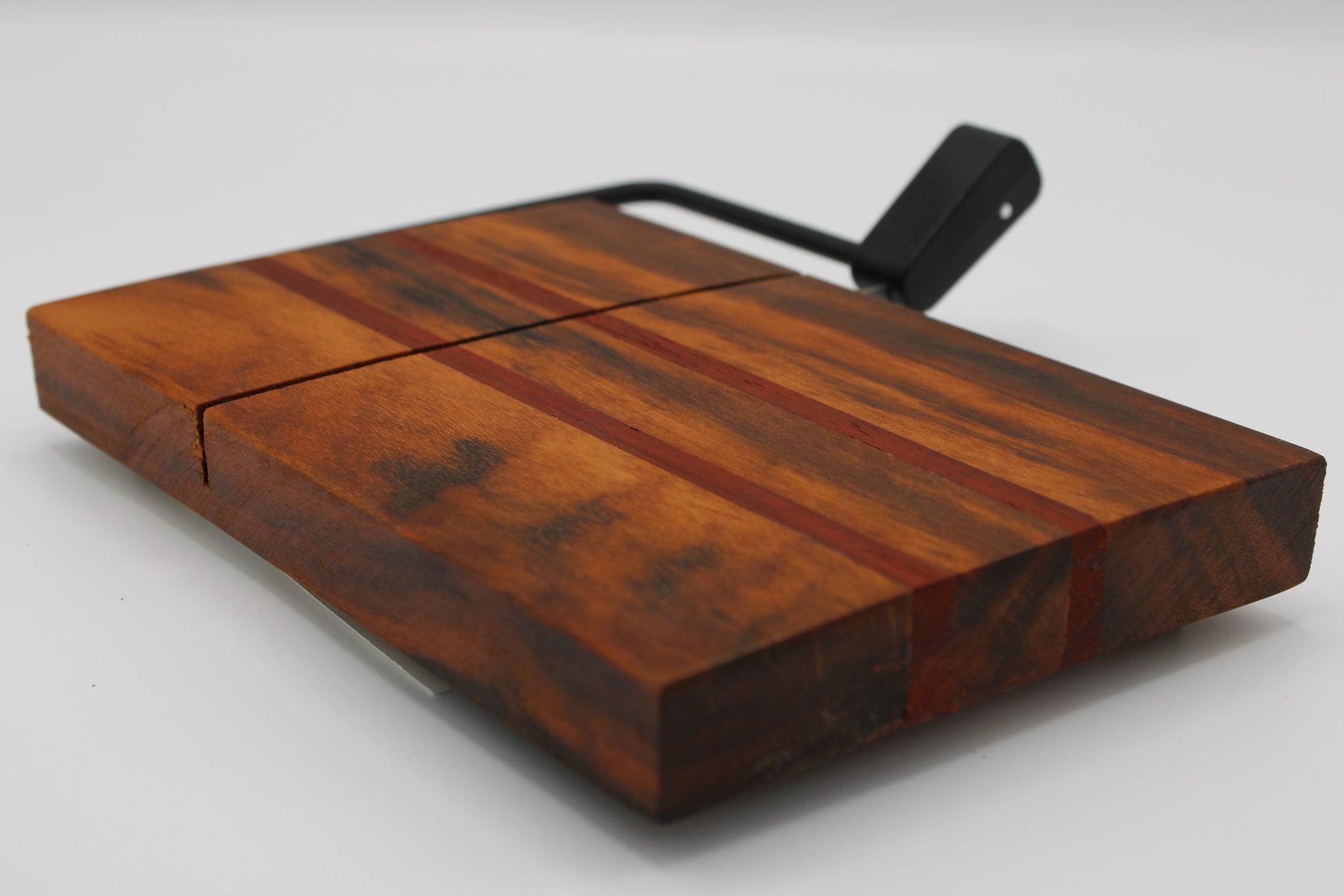 Wooden with cheese board with two red stripes on a white background