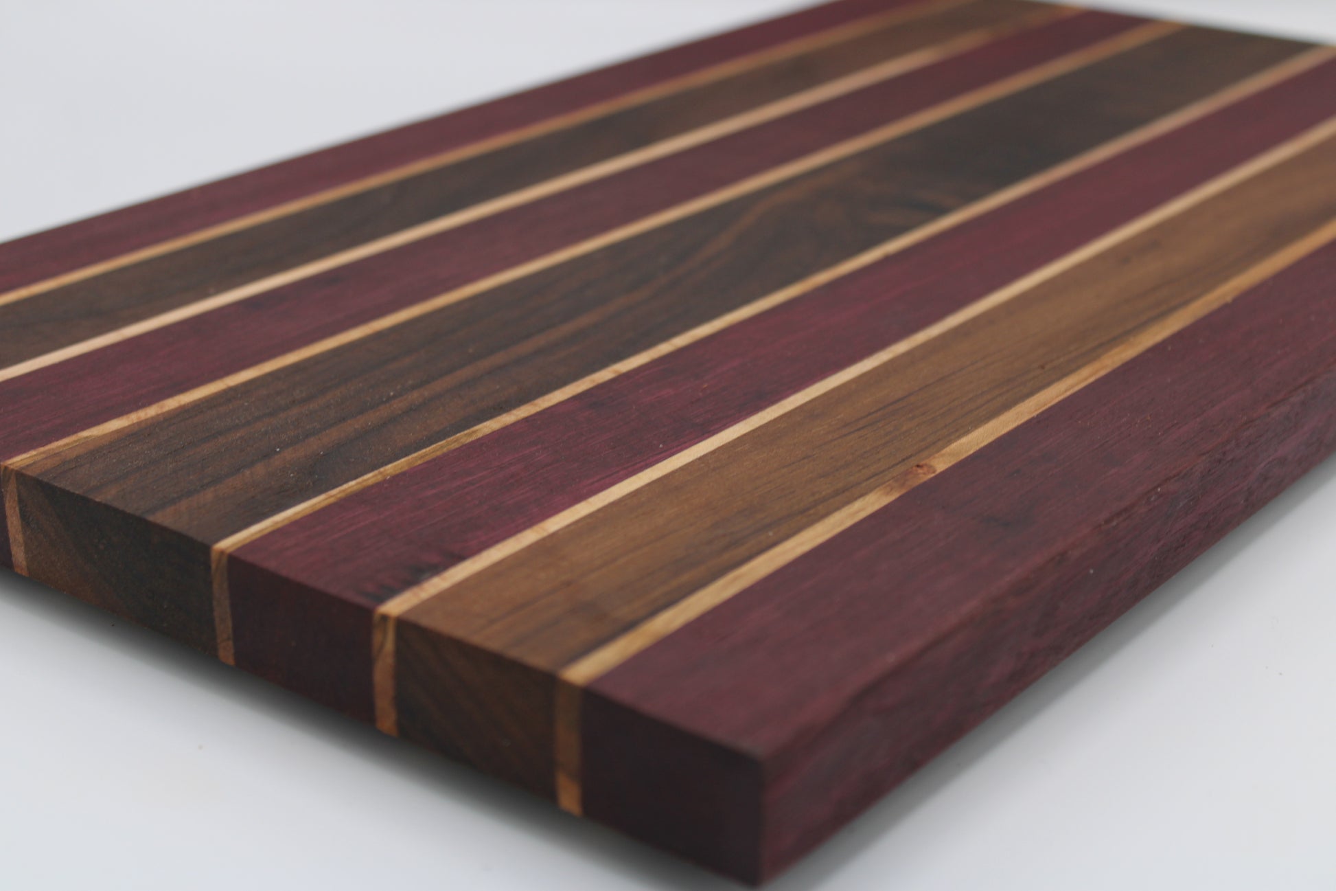 Wooden cutting board with striped pattern on a white background