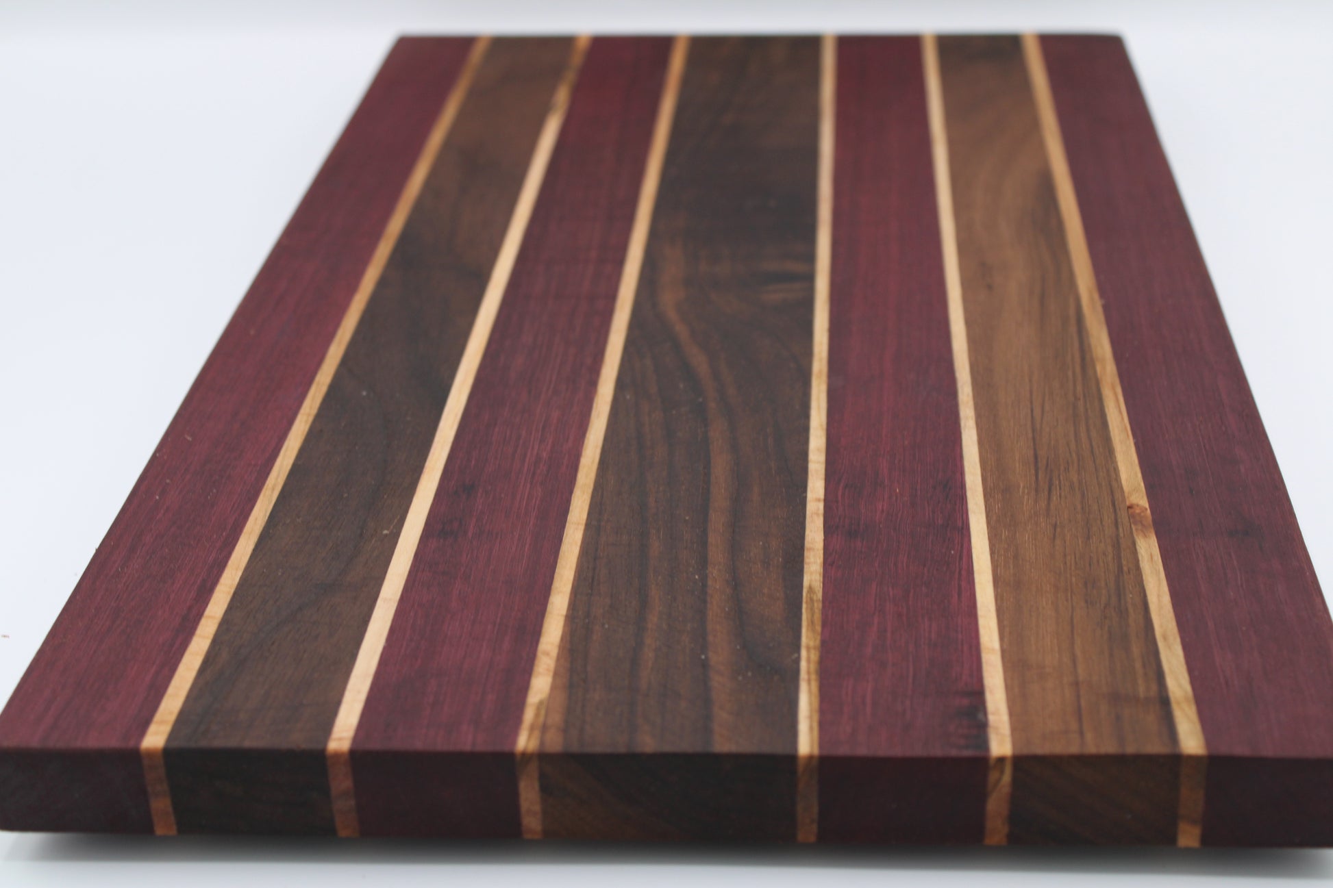 Wooden cutting board with striped pattern on a white background