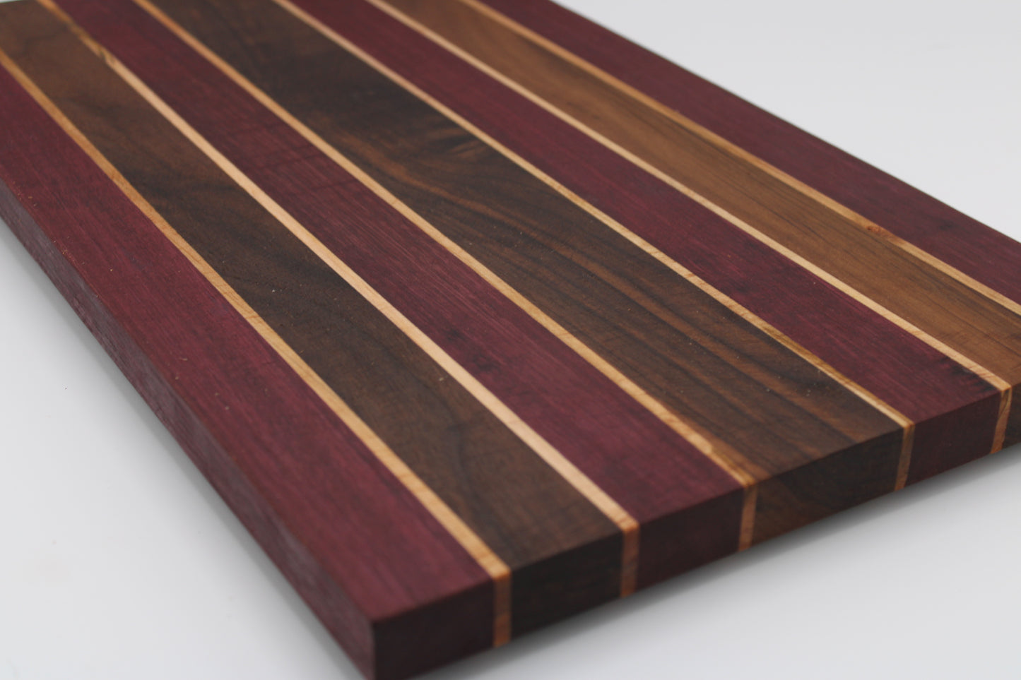 Wooden cutting board with striped pattern on a white background