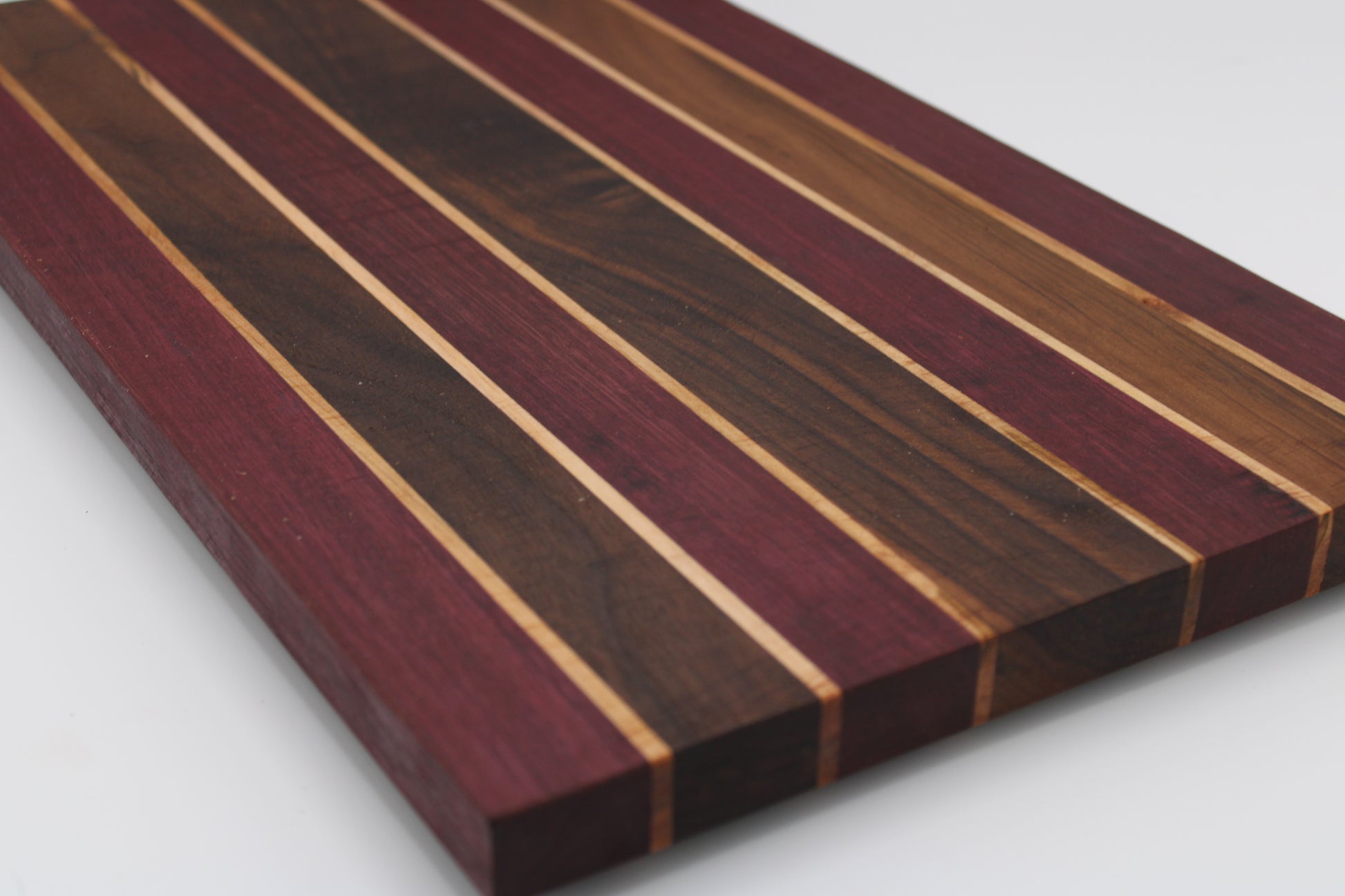 Wooden cutting board with striped pattern on a white background