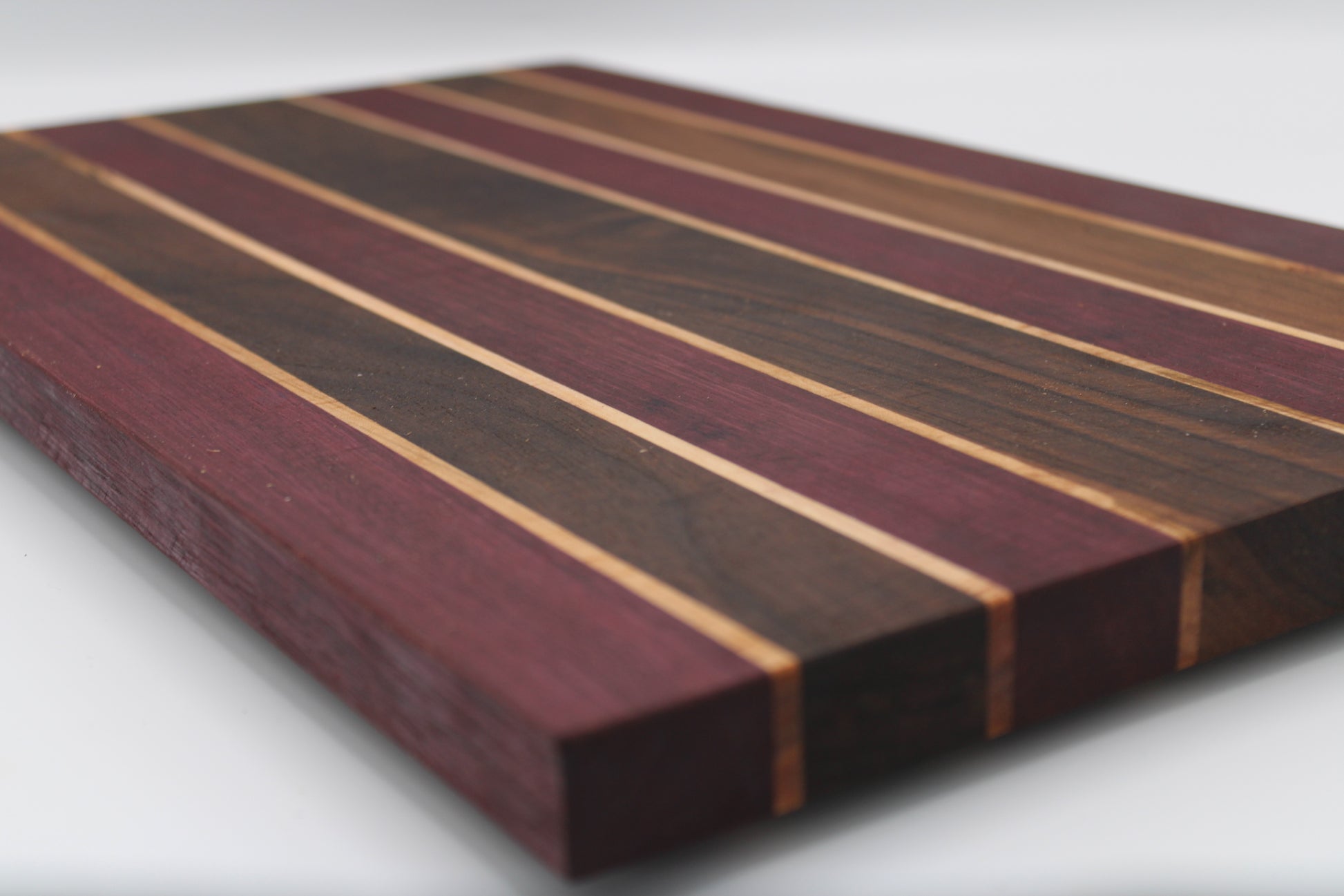 Wooden cutting board with striped pattern on a white background