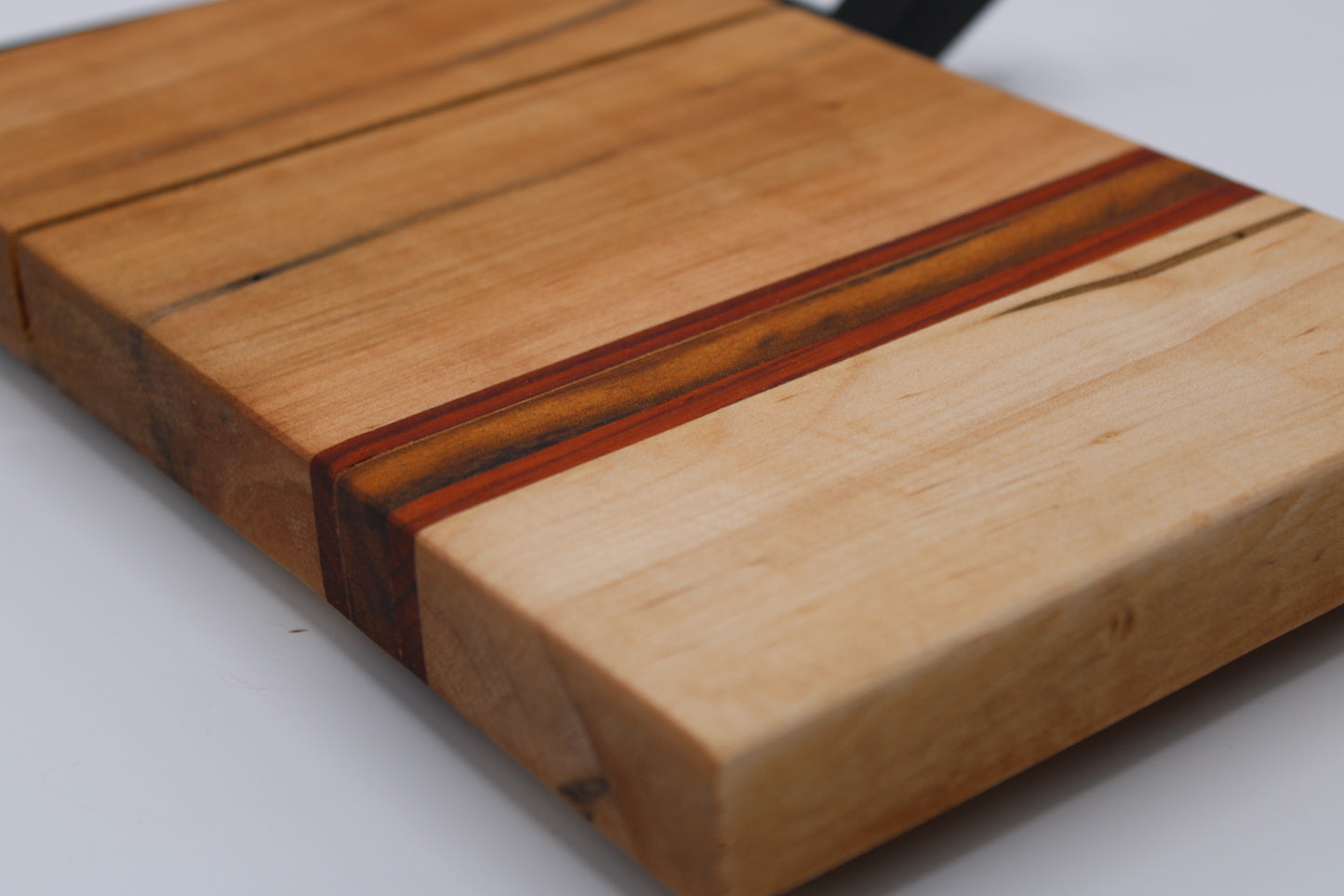Wooden cheese cutting board with slicer on a white background