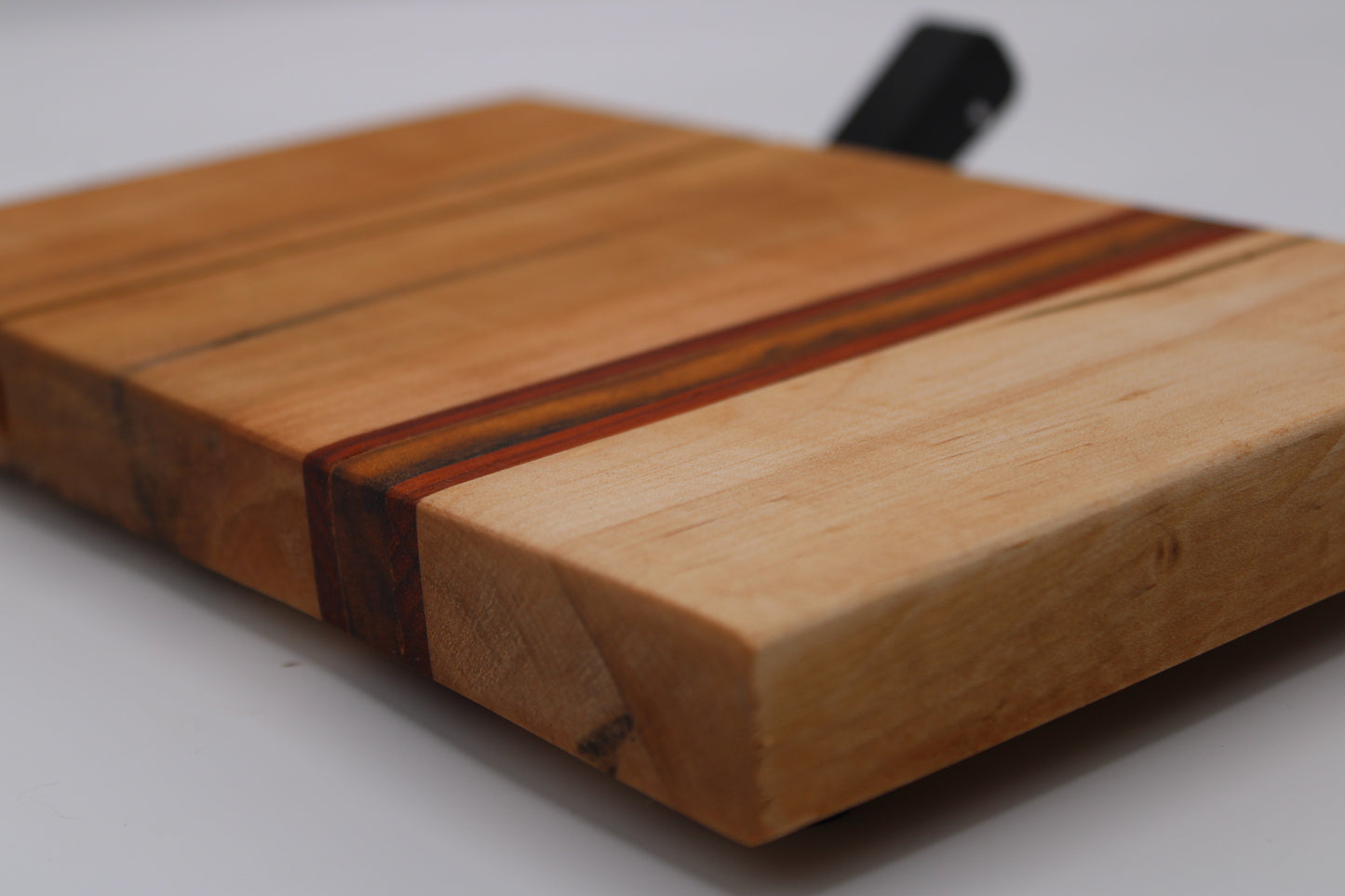 Wooden cheese cutting board with slicer on a white background