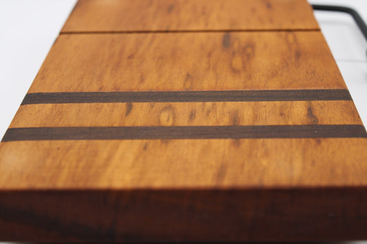 Wooden cheese cutting board with slicer on a light gray background