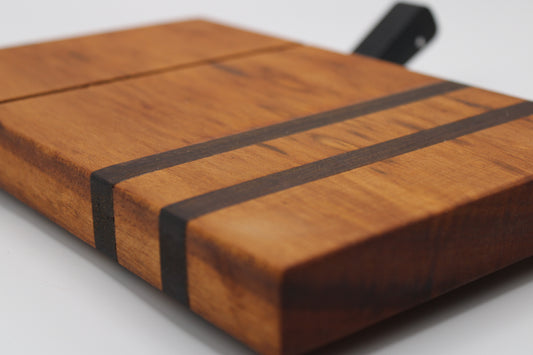 Wooden cheese cutting board with slicer on a light gray background