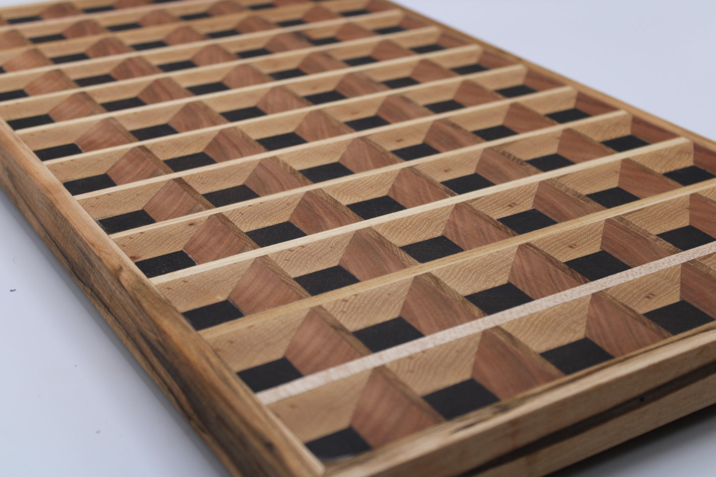 Wooden cutting board with a 3-D geometric pattern on a white background