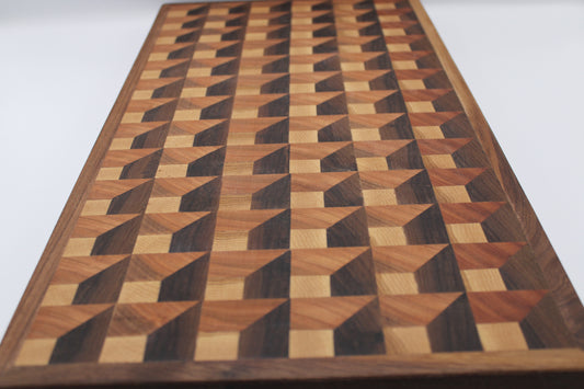 Wooden cutting board with a 3-D geometric pattern on a white background