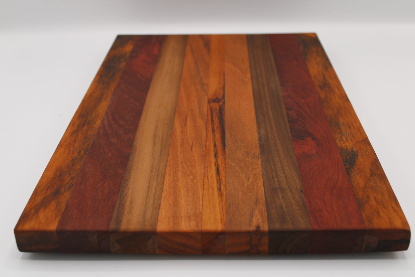 Wooden cutting board with a striped pattern on a white background