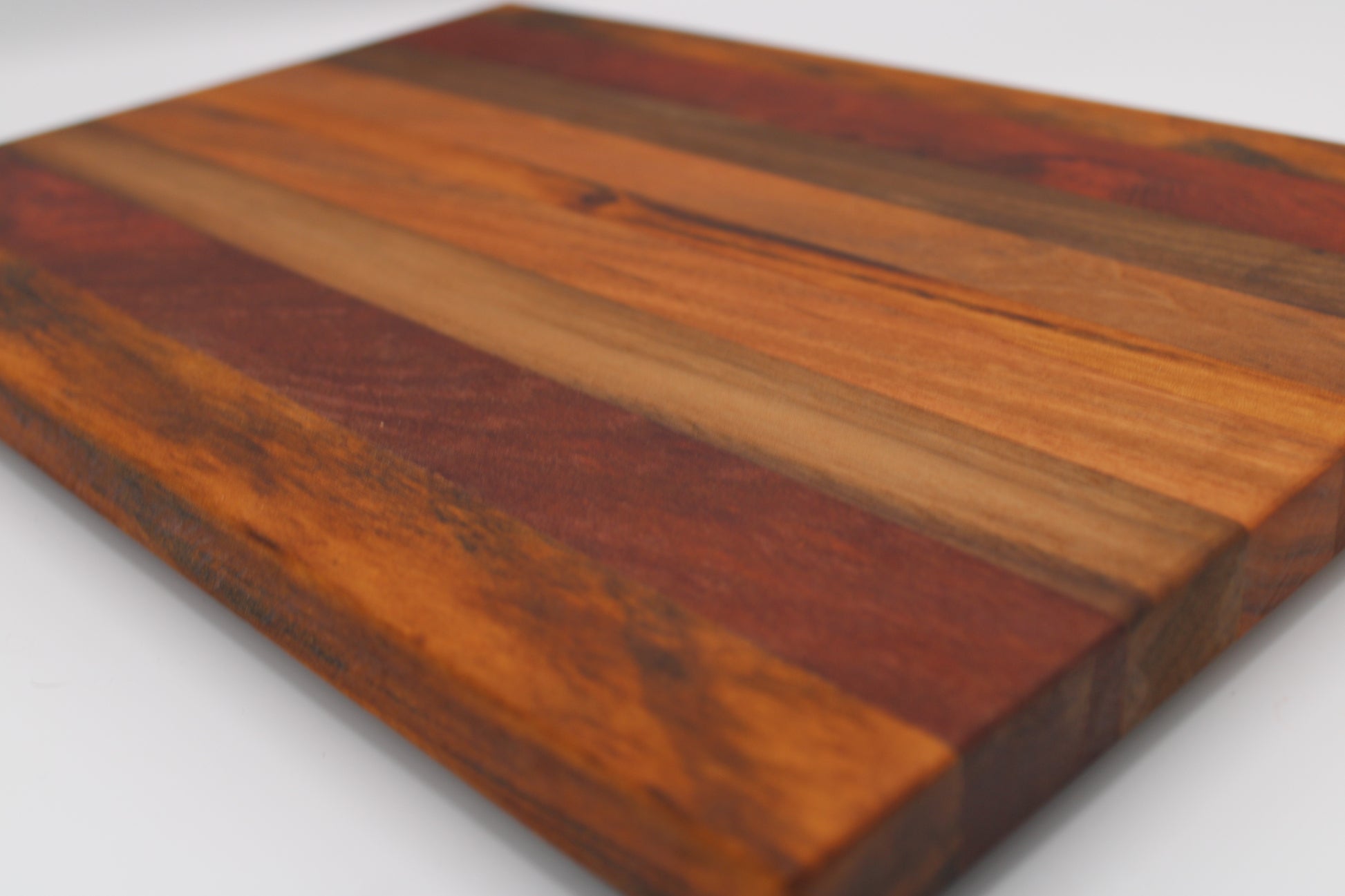 Wooden cutting board with a striped pattern on a white background