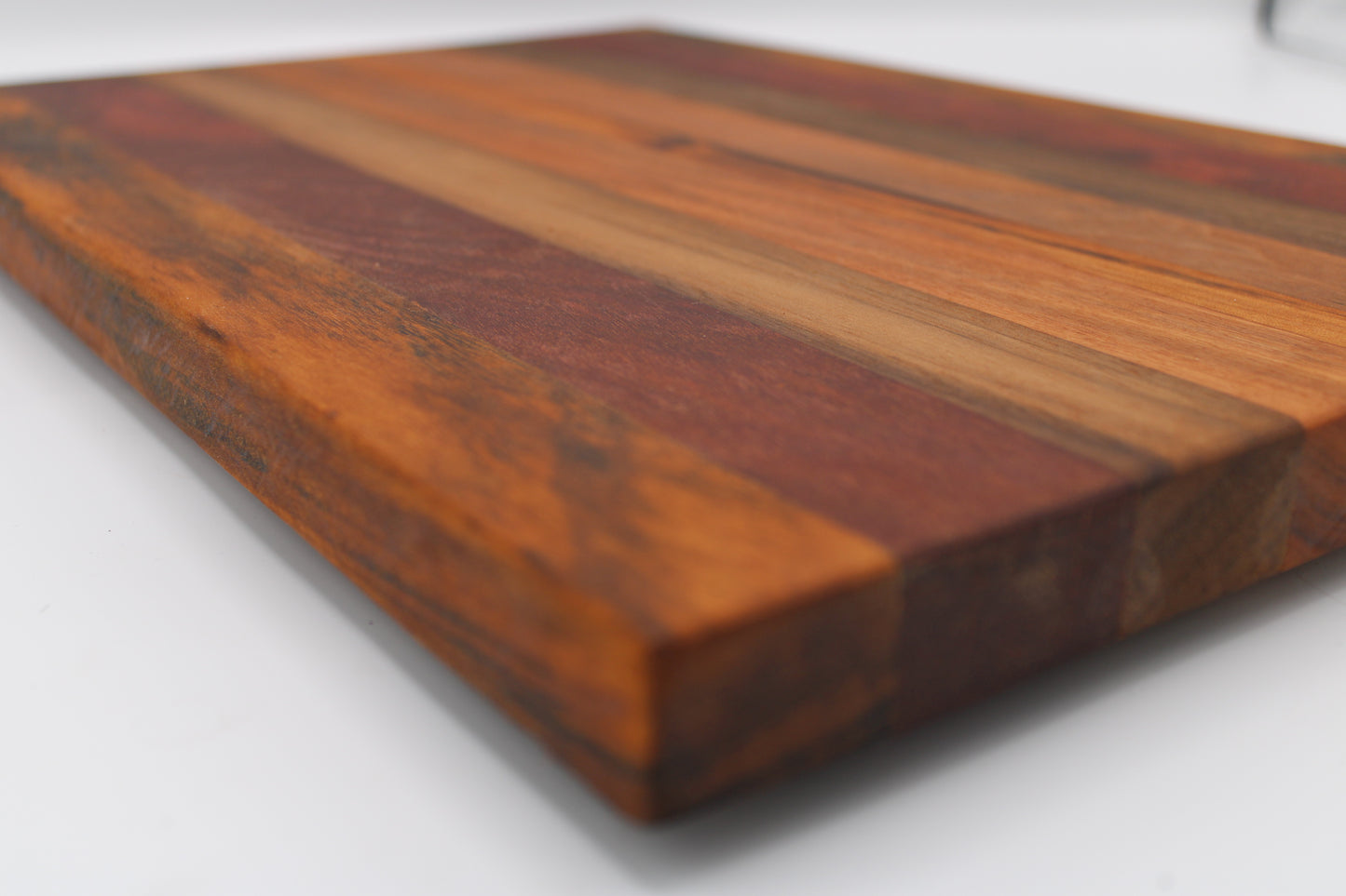 Wooden cutting board with a striped pattern on a white background