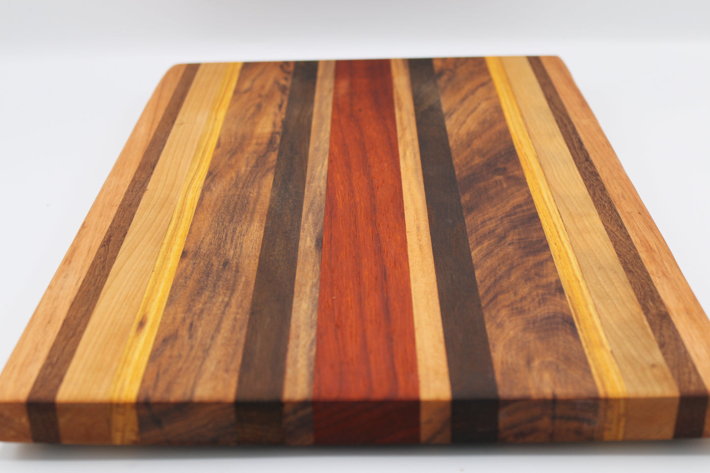 Wooden cutting board with striped pattern on a white background