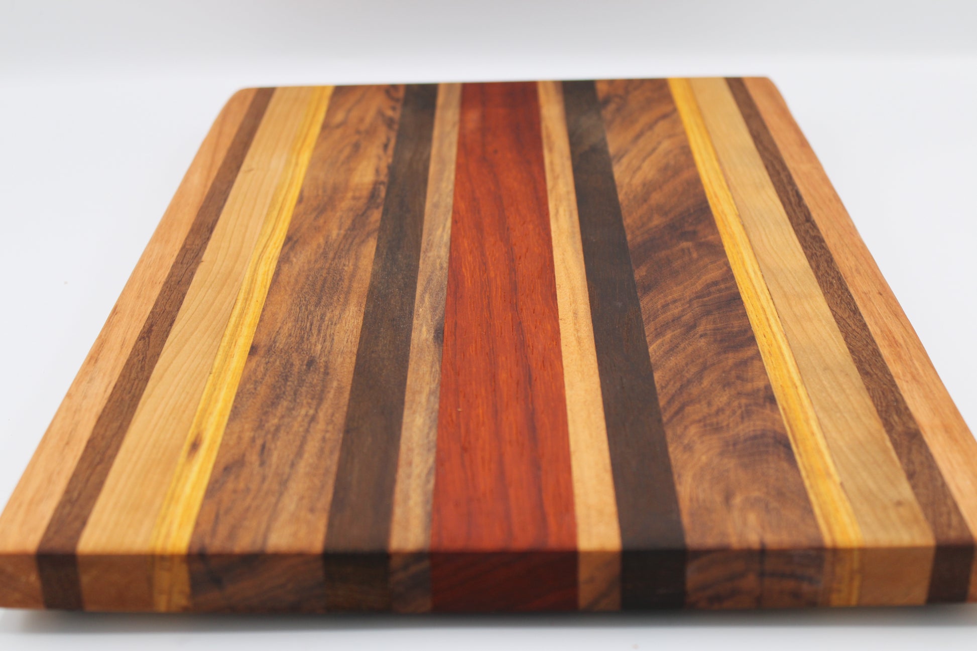 Wooden cutting board with striped pattern on a white background