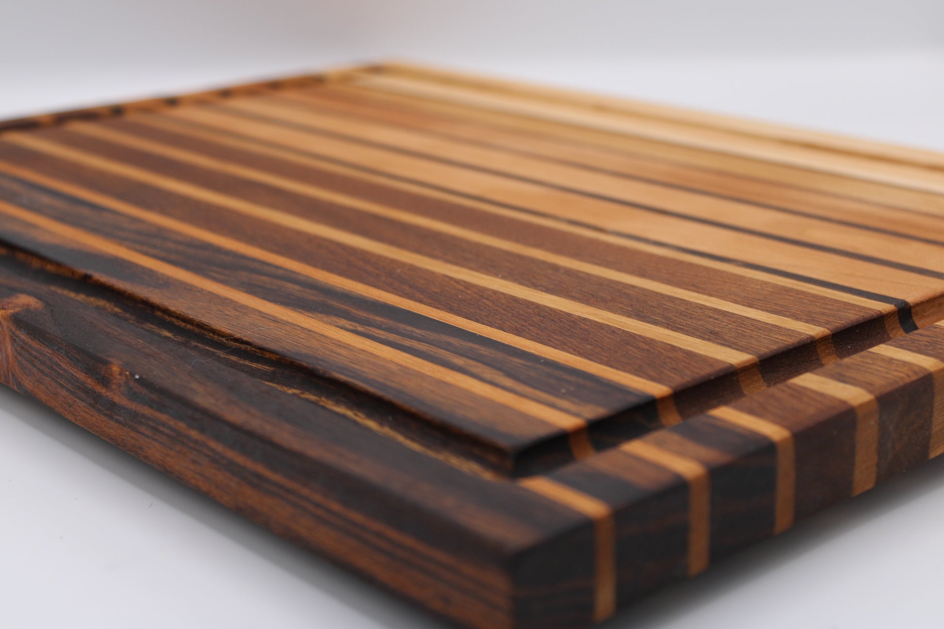 Wooden cutting board with striped pattern on a white background