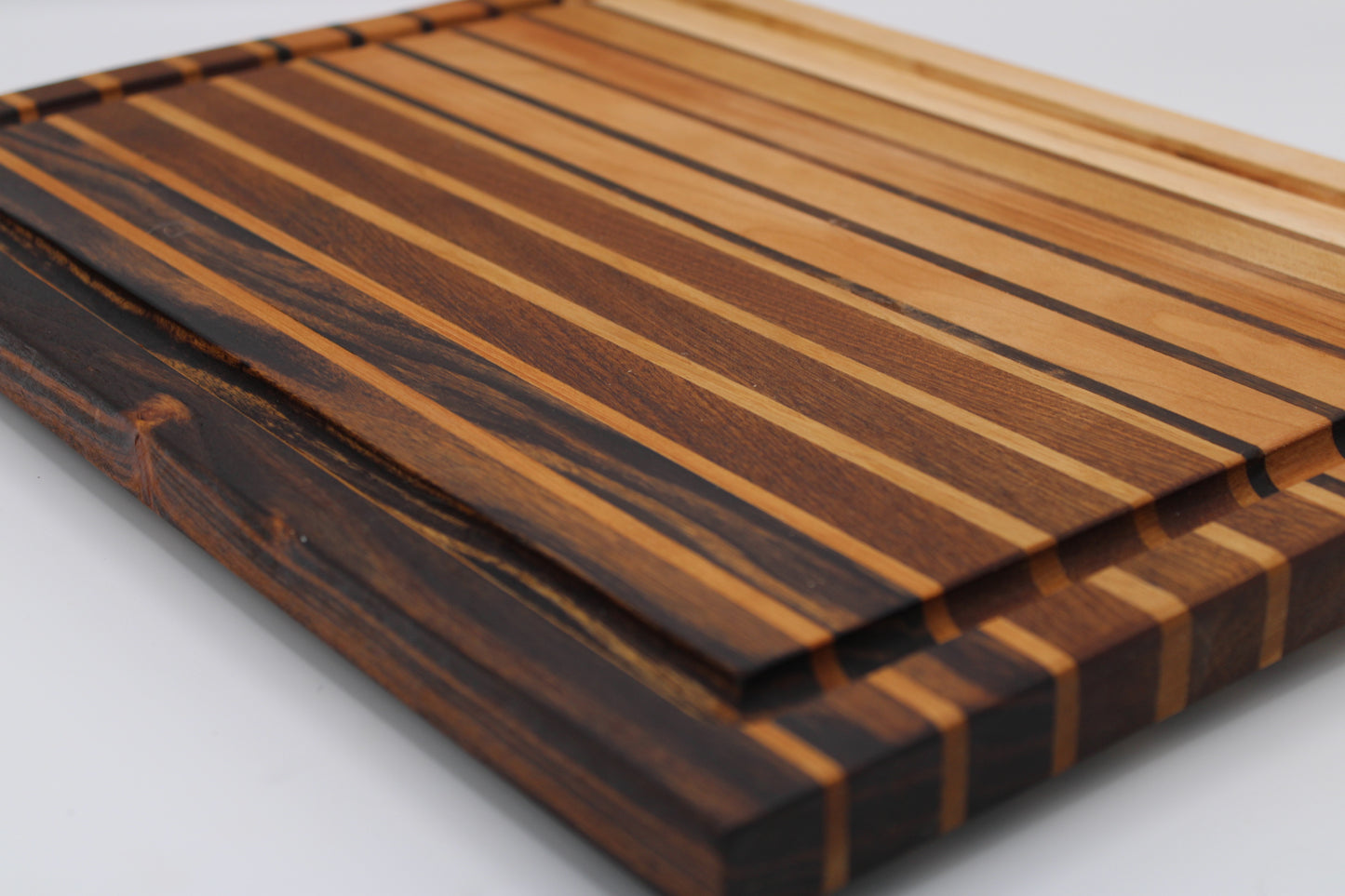 Wooden cutting board with striped pattern on a light gray background