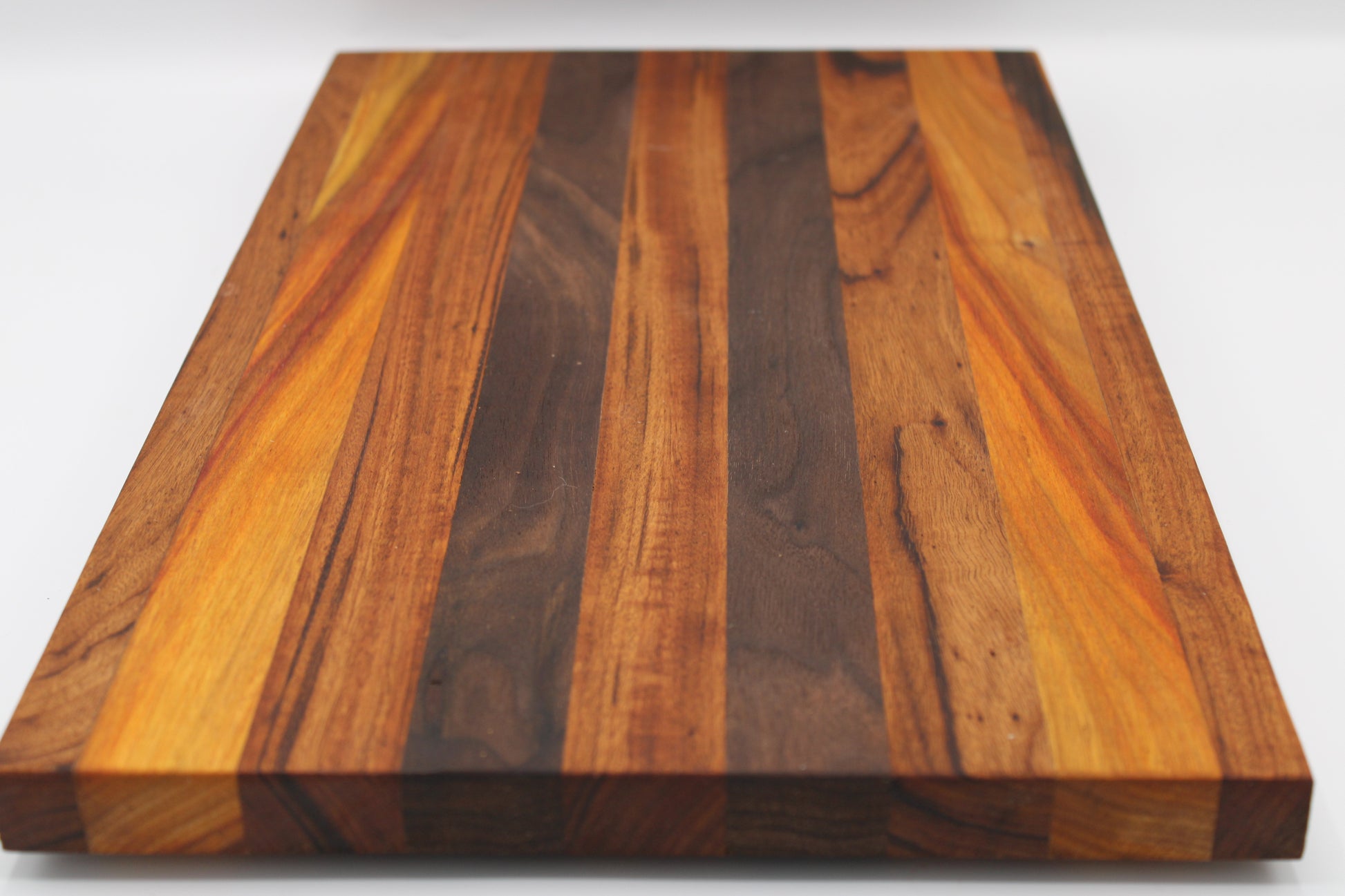 Wooden cutting board with a striped pattern on a white background