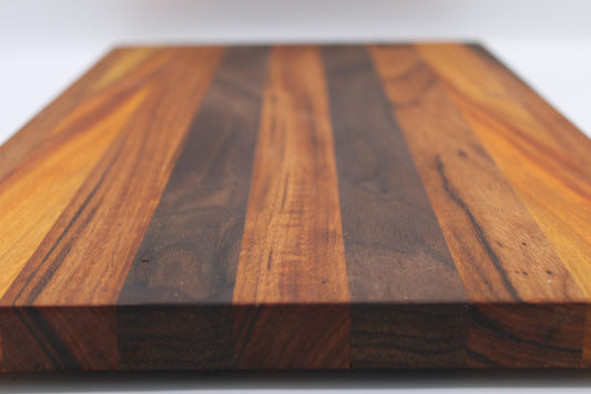 Wooden cutting board with a striped pattern on a white background