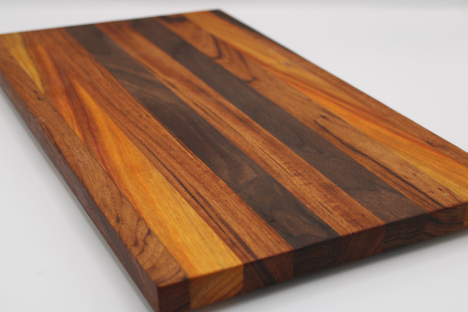 Wooden cutting board with a striped pattern on a white background