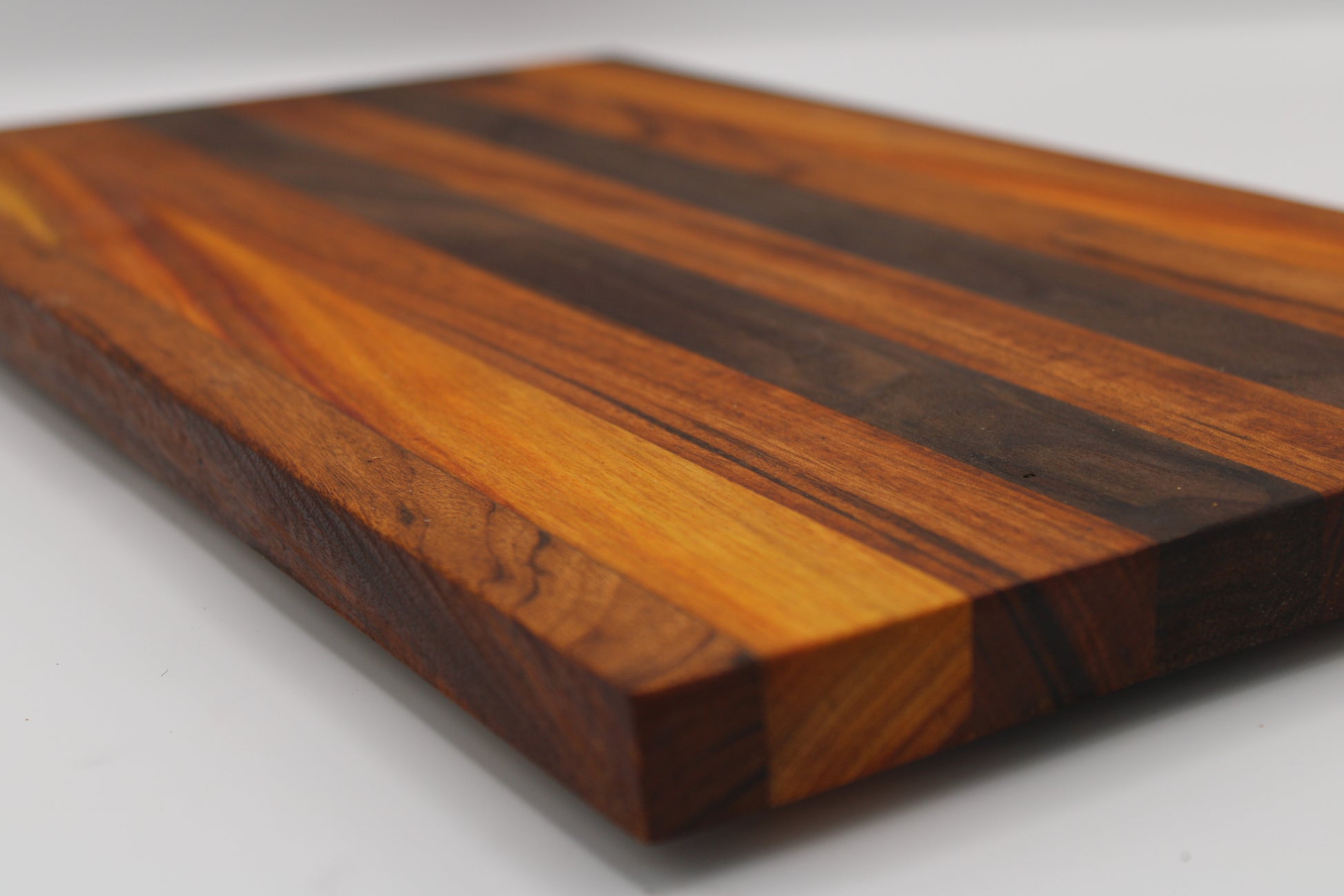 Wooden cutting board with a striped pattern on a white background