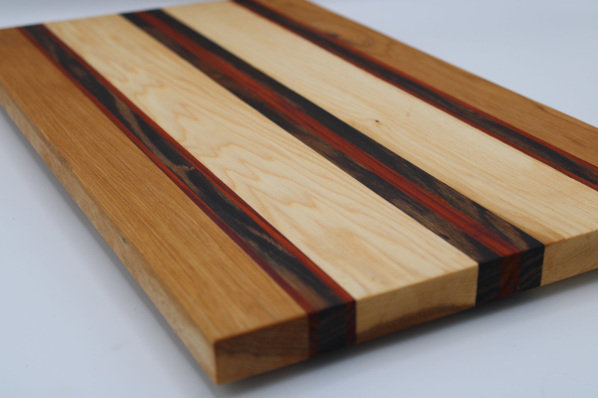 Wooden cutting board with striped pattern on a white background